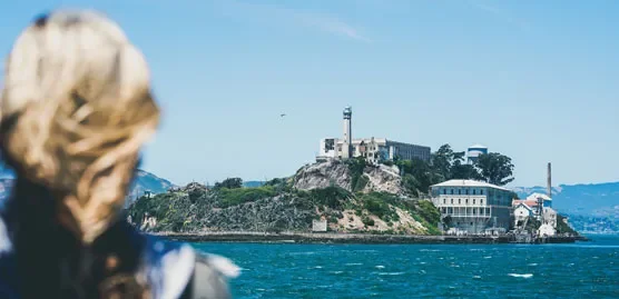 image of a woman looking over san francisco bay to alcatraz island