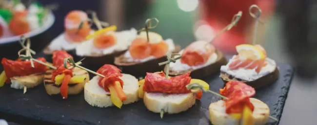 image of custom appetizers on bread and served on a stone dish