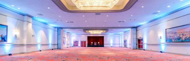 panoramic image of our ballroom empty with highlight lights on and stage showing