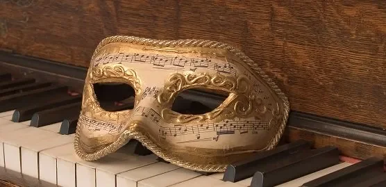 image of a mask sitting on a piano keyboard