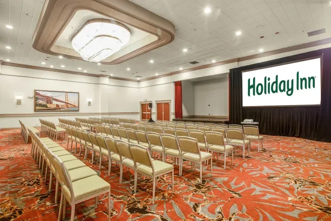 our crystal ballroom showing banquet set up for 5 with stage and screens